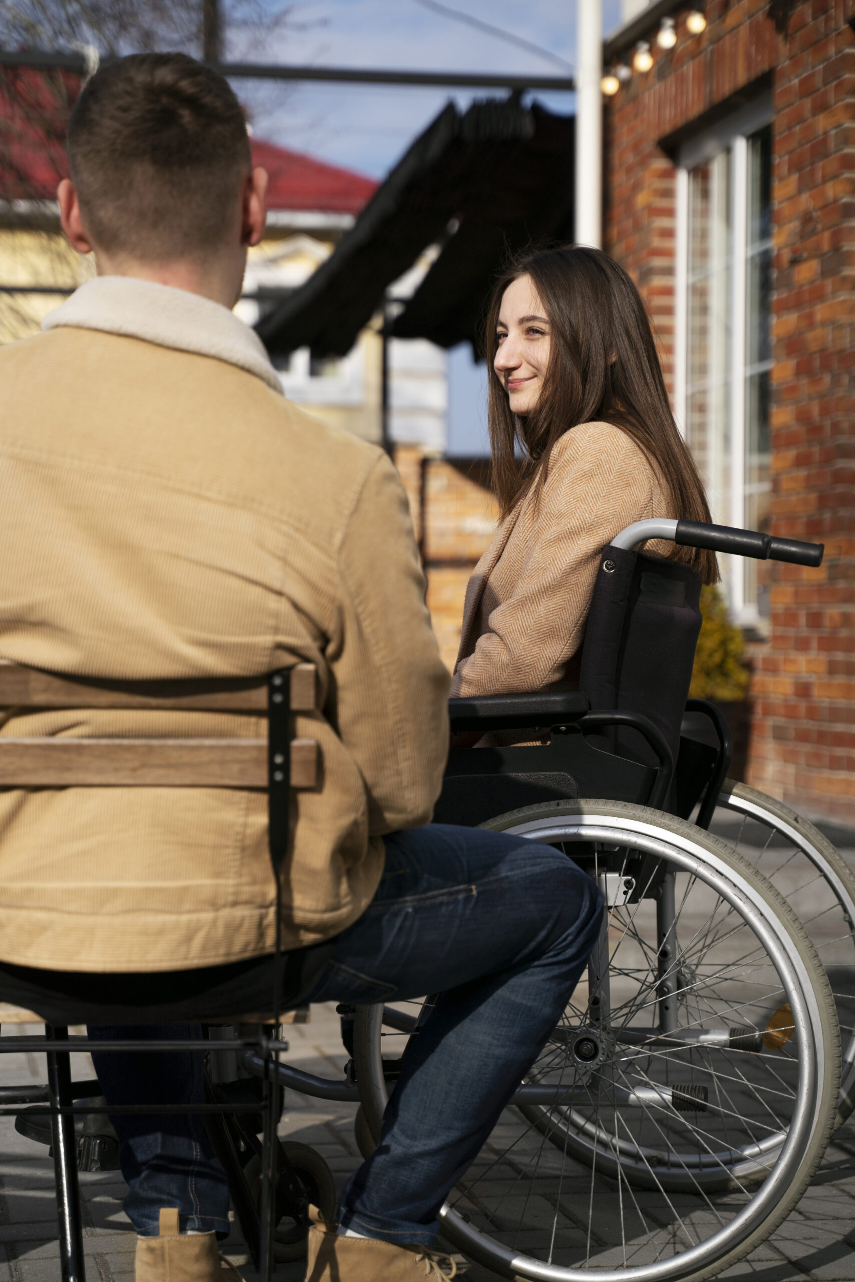 Woman using a wheelchair enjoying time outdoors with friends